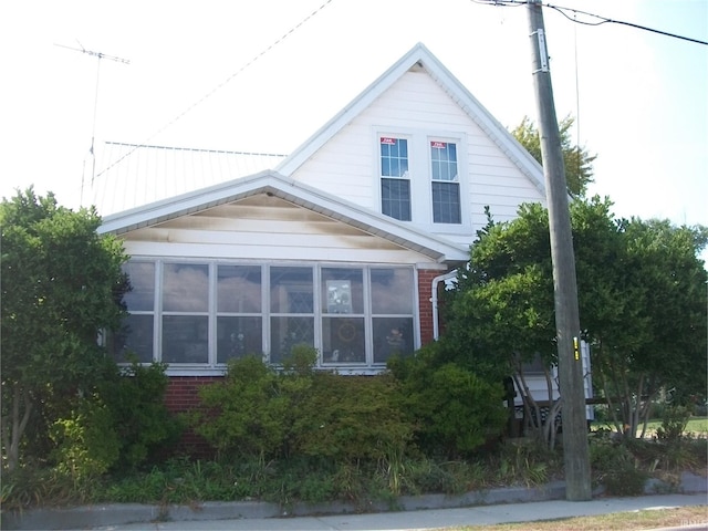 view of side of home with a sunroom