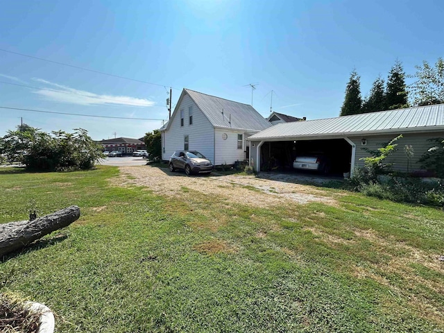 view of side of property with a lawn and a carport