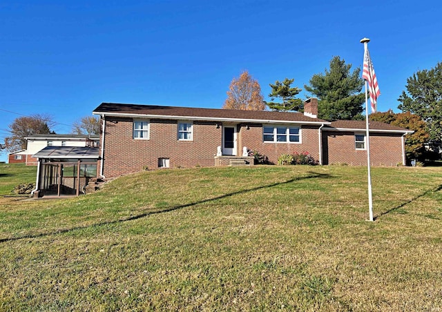 rear view of property with a yard