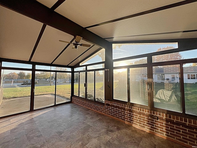 unfurnished sunroom with vaulted ceiling with beams and ceiling fan