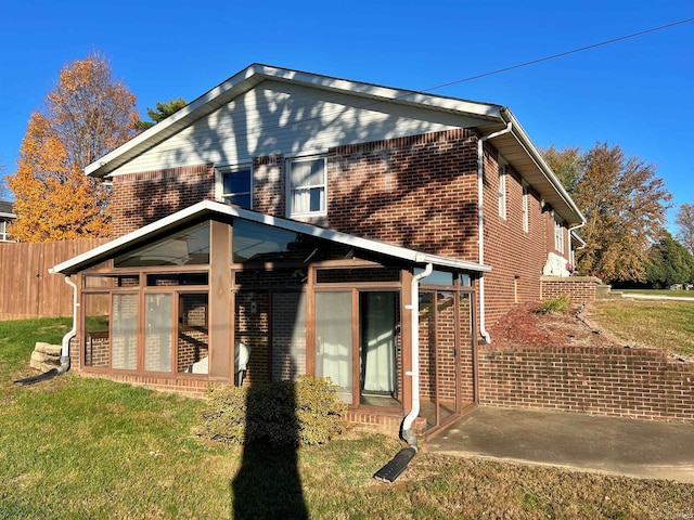 view of home's exterior featuring a patio and a lawn