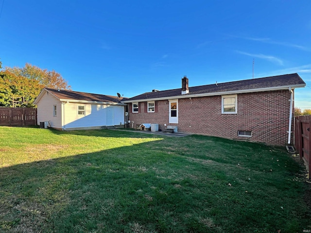 1504 E National Hwy, Washington, IN 47501 - rear view of property featuring entry steps, brick siding, a chimney, and cooling unit