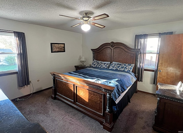 bedroom with a textured ceiling, dark colored carpet, and ceiling fan