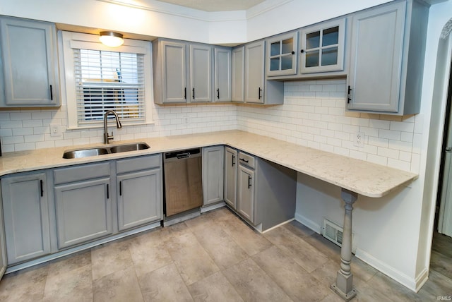 kitchen featuring dishwasher, gray cabinets, sink, and light stone counters