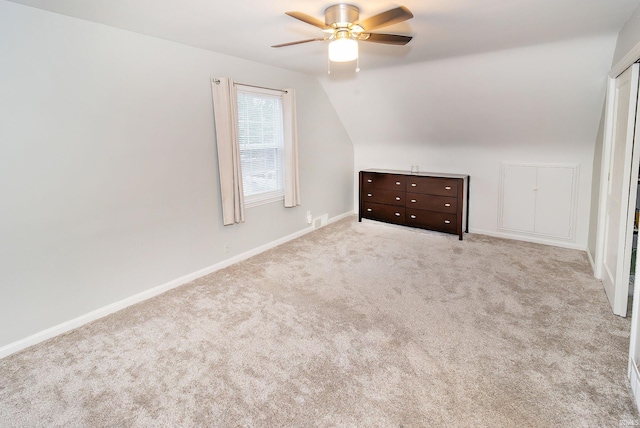 bonus room featuring ceiling fan, light colored carpet, and lofted ceiling