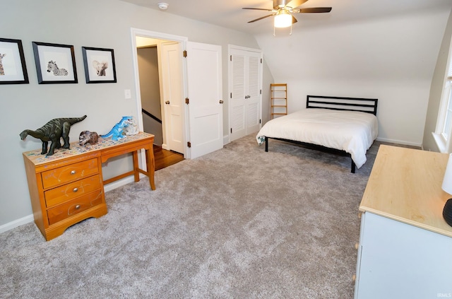 carpeted bedroom with ceiling fan, a closet, and lofted ceiling