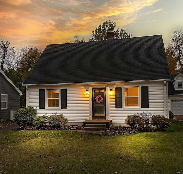 view of front of property featuring a garage and a yard