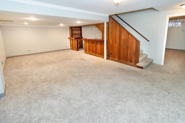 basement featuring ornamental molding and light colored carpet