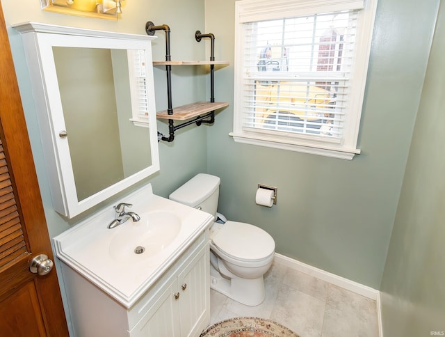 bathroom featuring toilet, vanity, and tile patterned floors