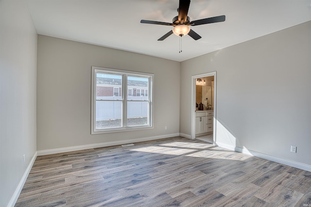 spare room featuring ceiling fan and light wood-type flooring