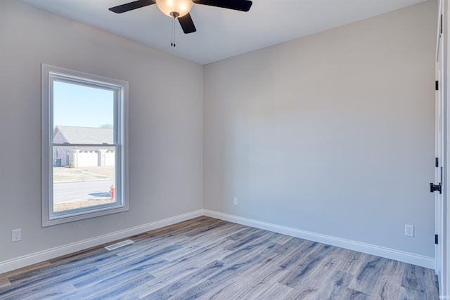 empty room featuring light hardwood / wood-style flooring and ceiling fan