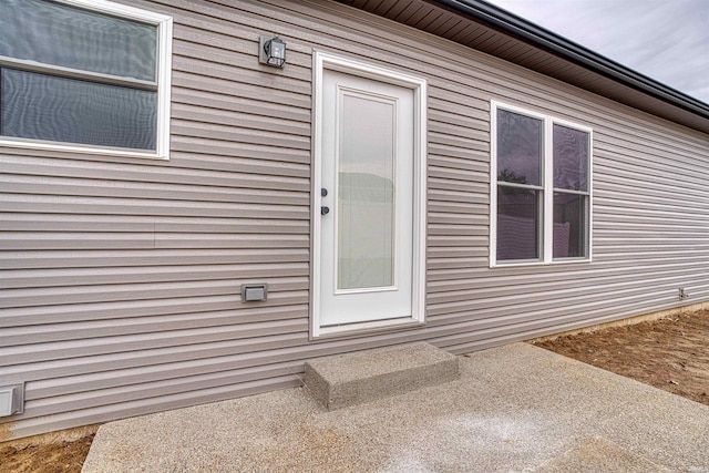 doorway to property featuring a patio area