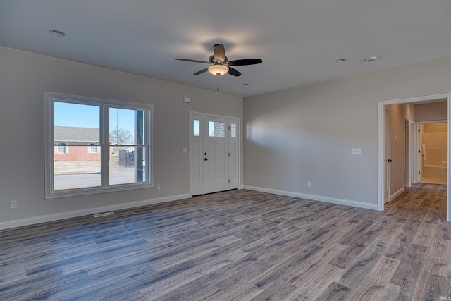 foyer featuring wood-type flooring and ceiling fan