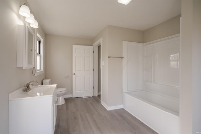 full bathroom with toilet, bathtub / shower combination, vanity, and wood-type flooring