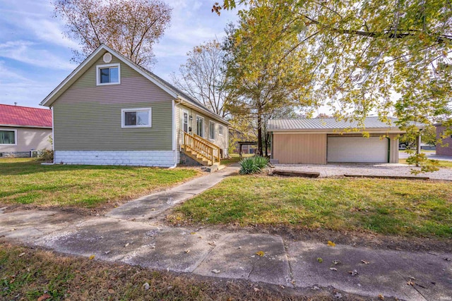 view of side of property with a garage and a lawn