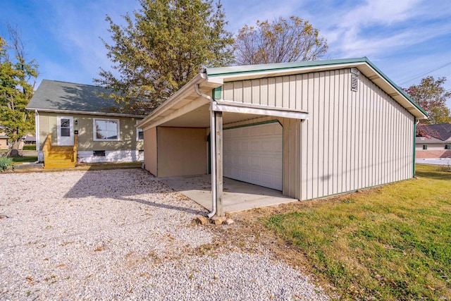 exterior space featuring a front lawn, a garage, and a carport