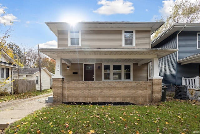 view of front of house with a porch and a front lawn