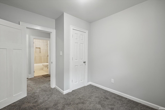 unfurnished bedroom featuring dark carpet