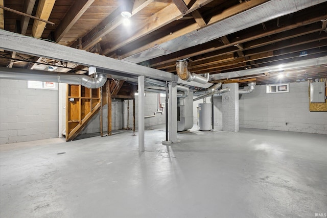 basement with electric panel, gas water heater, and heating unit