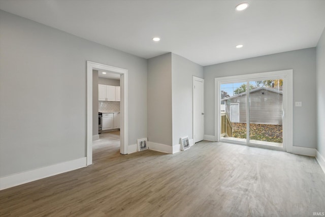 empty room with hardwood / wood-style flooring