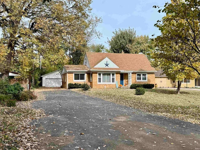 view of front of property featuring an outbuilding and a garage