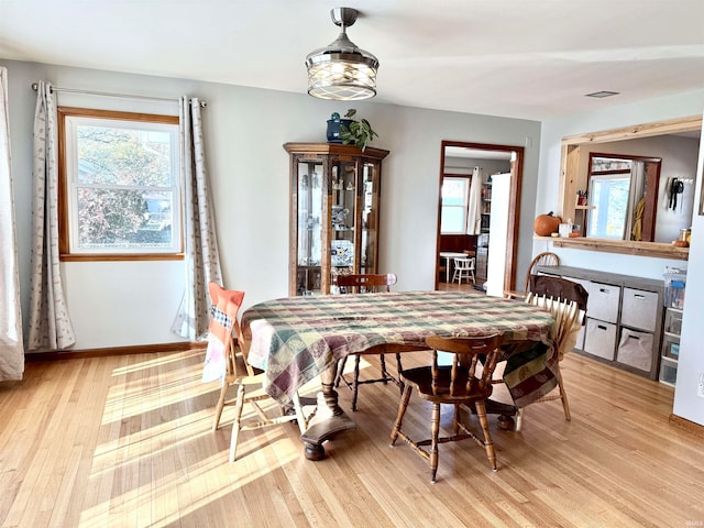 dining space with light hardwood / wood-style floors