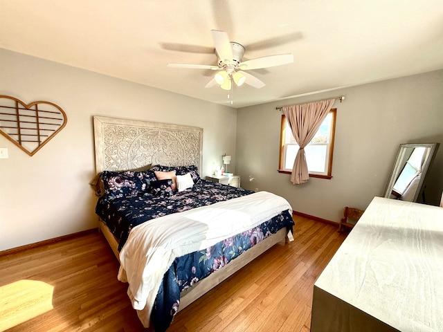 bedroom featuring hardwood / wood-style floors and ceiling fan