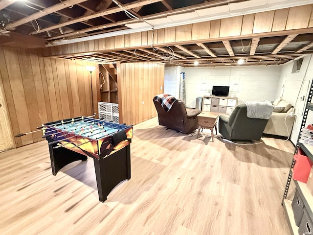 playroom featuring wood walls and wood-type flooring