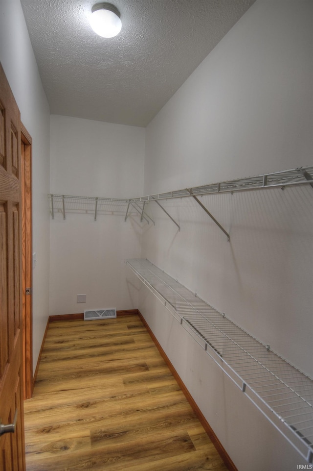 walk in closet featuring hardwood / wood-style floors