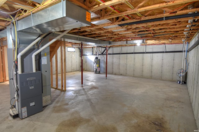 basement featuring gas water heater and heating unit