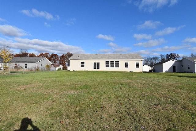 back of house with a lawn