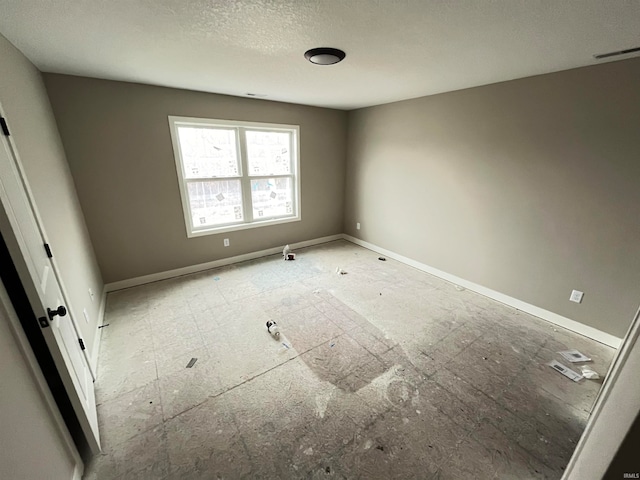 empty room with a textured ceiling