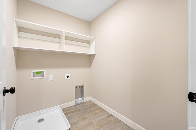 laundry room with hookup for a washing machine, light wood-type flooring, and electric dryer hookup