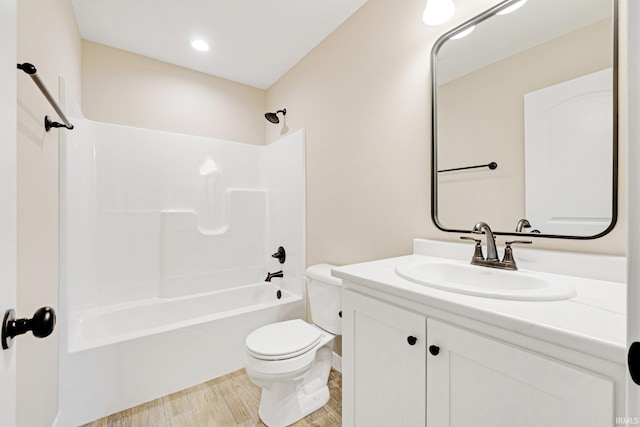 full bathroom featuring shower / bathing tub combination, vanity, toilet, and hardwood / wood-style floors