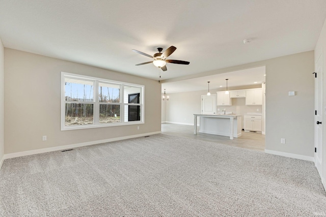 4805 Falcon Pkwy, New Haven, IN 46774 - unfurnished living room featuring a ceiling fan, light colored carpet, and baseboards