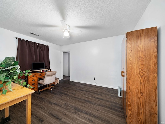 office with ceiling fan, dark hardwood / wood-style floors, and a textured ceiling