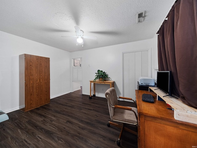 home office featuring a textured ceiling, ceiling fan, and dark hardwood / wood-style flooring