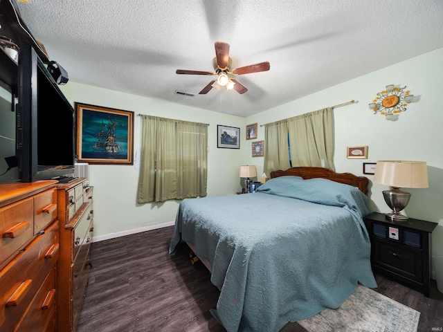 bedroom featuring ceiling fan, a textured ceiling, and dark hardwood / wood-style floors