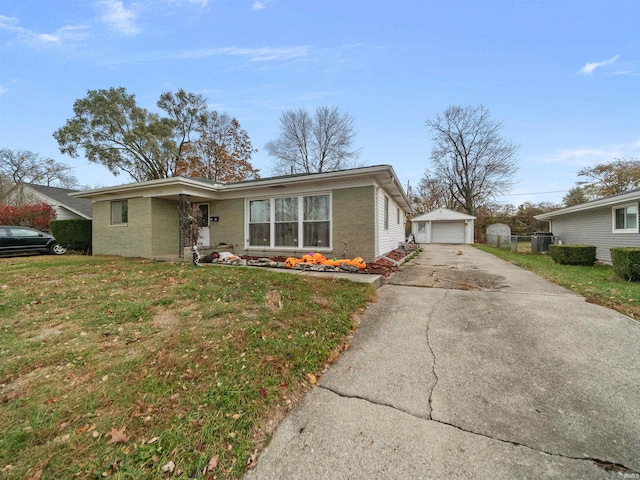 view of front facade featuring a front yard, an outdoor structure, and a garage