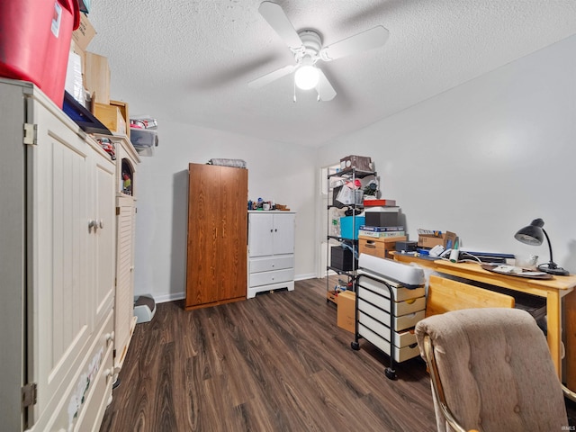 office space with ceiling fan, dark wood-type flooring, and a textured ceiling