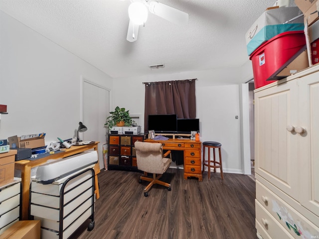 office area featuring a textured ceiling, dark wood-type flooring, and ceiling fan