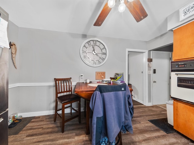 dining area with ceiling fan and dark hardwood / wood-style floors