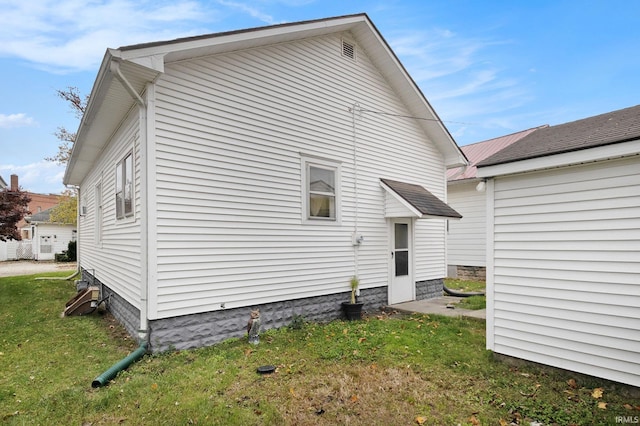 rear view of house featuring a yard