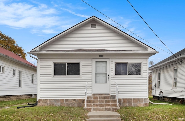 bungalow-style house with a front yard