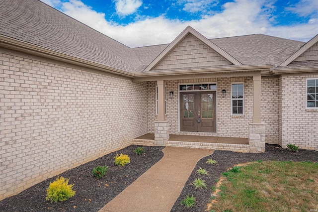 view of exterior entry featuring covered porch