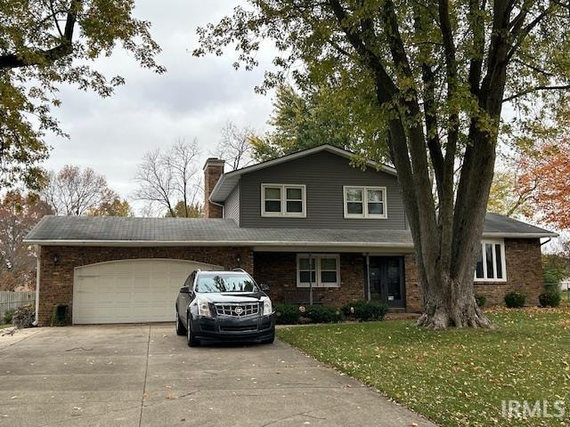 view of property featuring a garage and a front yard