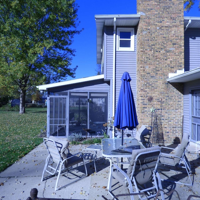 view of patio featuring a sunroom