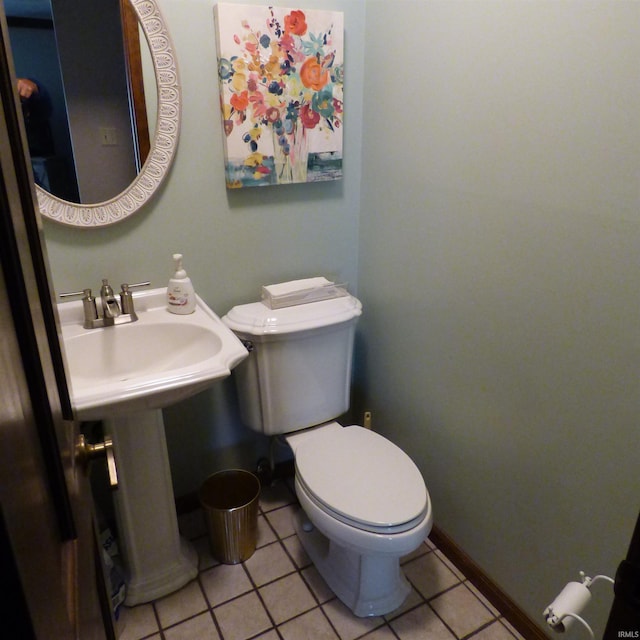 bathroom with tile patterned flooring and toilet