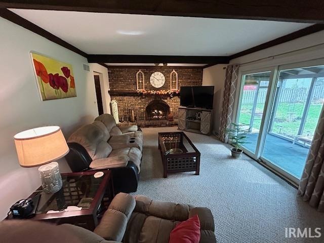 carpeted living room with crown molding and a brick fireplace