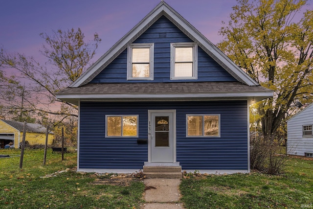 bungalow featuring a lawn